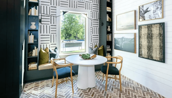 A dining room with a white table and chairs.